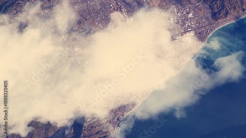 Satellite view of Odawara coastal city in Japan with moving clouds, animation based on Nasa imagery