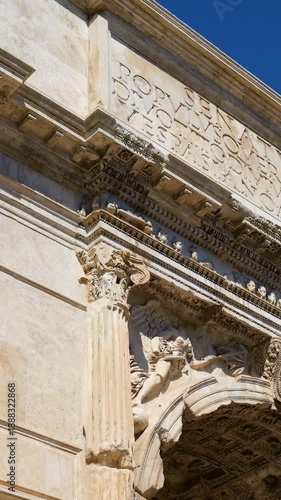 ornate roman triumphal arch carved corinthian columns friezes latin inscriptions coffered ceiling under clear sky rome italy coffer architecture historic monument 