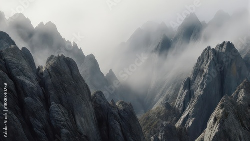 Misty Mountain Peaks Emerge from Foggy Haze in Dramatic Landscape.