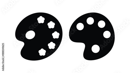 Two black paint palettes with circular wells a striking silhouette