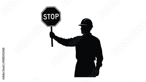 Worker holding a stop sign depicted in stark black silhouette