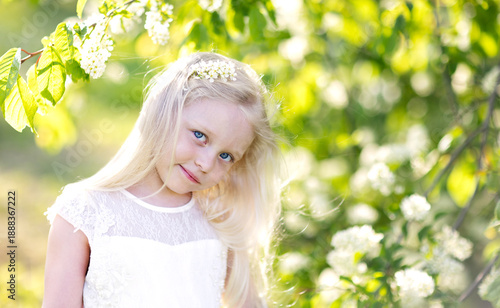 a little girl with a glowing flowering tree background.