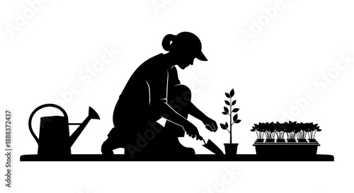 A person is planting a seedling in a pot with a watering can nearby