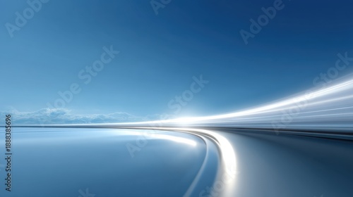 Smooth winding road with motion blur against a vibrant blue sky showcasing tranquility and speed in a serene landscape