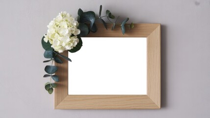 Empty wooden photo frame decorated with white flowers and eucalyptus branches
