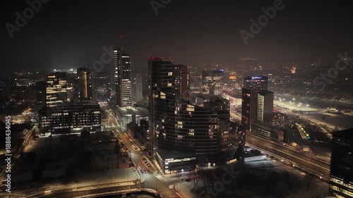 Wallpaper Mural Aerial night view of Vilnius city skyline with modern high-rise buildings, illuminated streets, and urban lights showcasing vibrant city life in Lithuania. Torontodigital.ca