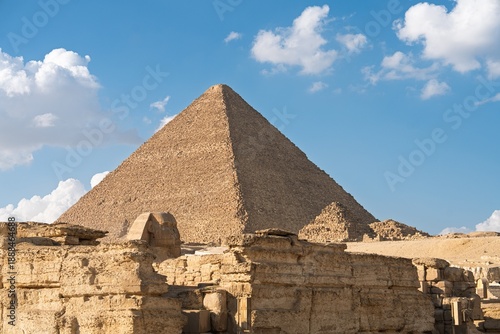 A stunning view of the Pyramids of Giza, majestic ancient structures under a vibrant blue sky. This image captures the essence of history and culture, ideal for educational and creative projects.
