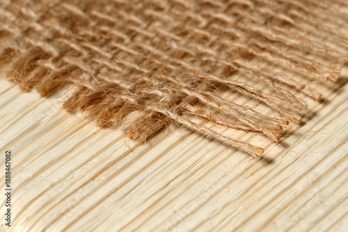 Close-up view of natural fibers on a wooden surface in soft light
