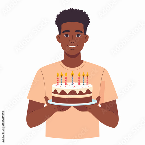 A young man holding a birthday cake with lit candles in a celebratory scene from a frontal viewpoint