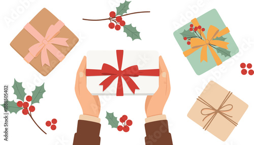 Top view of human hands holding a gift box surrounded by wrapped Christmas presents and holly berry branches isolated on white background.