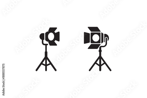Two black silhouettes of studio lights with barn doors on tripods on a white background