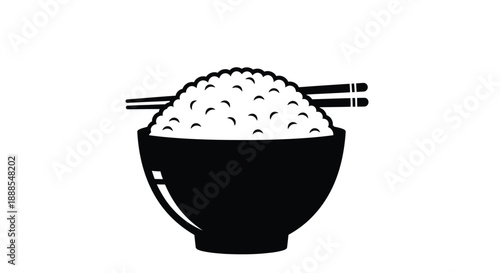 A black bowl filled with rice and chopsticks a striking silhouette