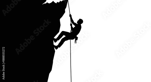 Silhouette of a rock climber ascending a cliff with a rope conveying determination