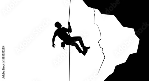 Silhouette of a daring rock climber descending a cliff face with rope support displays athleticism