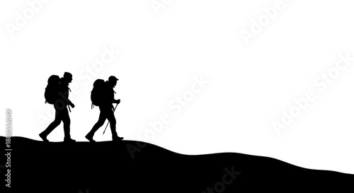 Silhouetted hikers traverse a mountainous landscape, embodying adventure and exploration against a
