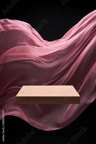 Elegant wooden stage with flowing pink fabric against a dark background, perfect for product displays or cosmetic showcases