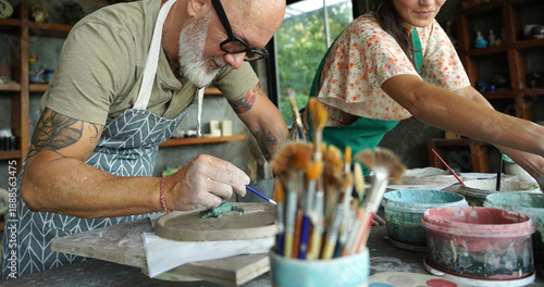A happy couple makes ceramic plates in a workshop