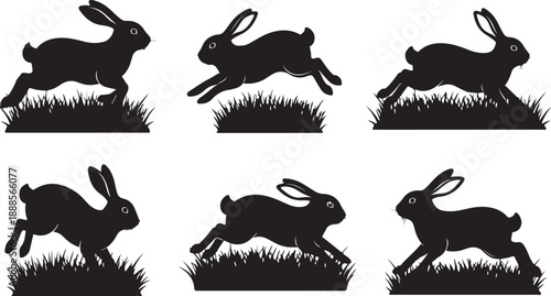 Six black rabbit silhouettes running in grassy field together