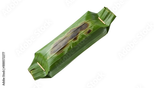 Grilled fish cake wrapped in banana leaf shows slight charring on the casing.