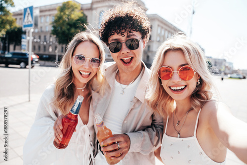 Photography Man and two young beautiful smiling hipster female