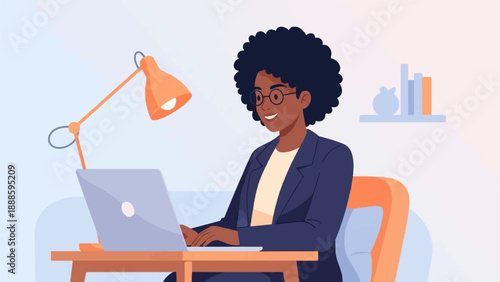 A woman in a blue blazer works on a laptop with a desk lamp