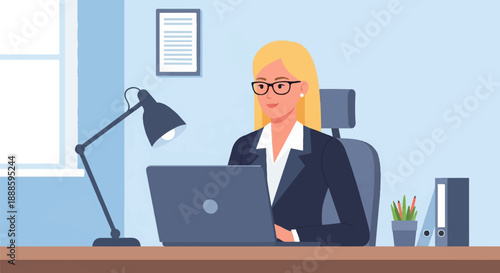 A woman in a suit and glasses works on a laptop at a desk