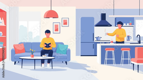 A man reads a book on a couch while another makes coffee in a modern kitchen