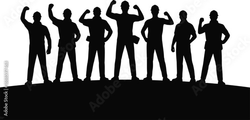 Seven strong construction workers in hard hats stand together on a hill with fists raised