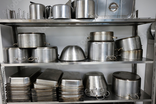 Details with stainless steel kitchen pots, pans and utensils in a professional canteen or hospital kitchen
