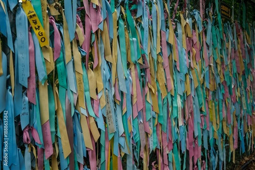 Obraz na płótnie Prayer ribbons tied to a chain link fence, symbolizing hope for reunification be