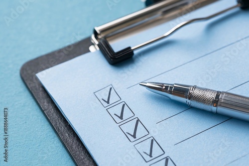 Checklist on clipboard with pen ready for use during task completion at desk in office setting