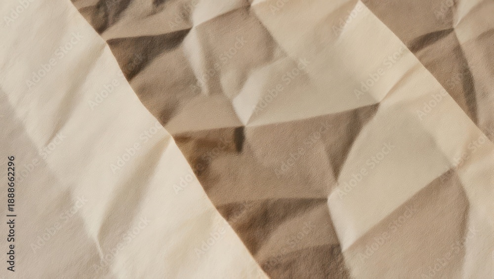 Obraz premium Close-up of folded fabric with diamond pattern in beige and brown tones, soft texture