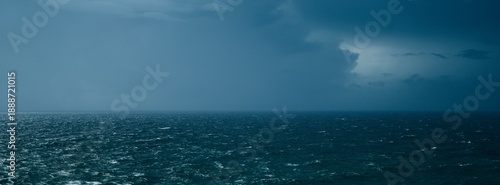 Vast Moody Ocean Horizon with Choppy Dark Blue Water Under a Dramatic Stormy Sky - Wide Panoramic Seascape Background