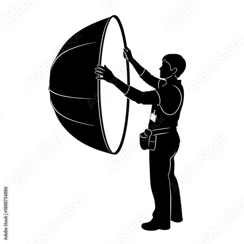 Photographer assistant holding reflector while preparing for shoot  