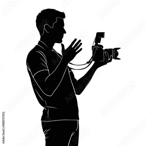 A studio photographer holds a camera and gestures while shooting.  