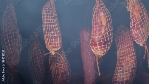 Smoking and curing meat using traditional methods in smokehouse.