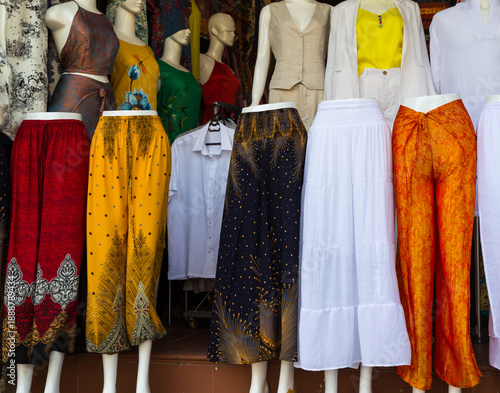 Elegant mannequins displaying formal fashion in boutique doorway