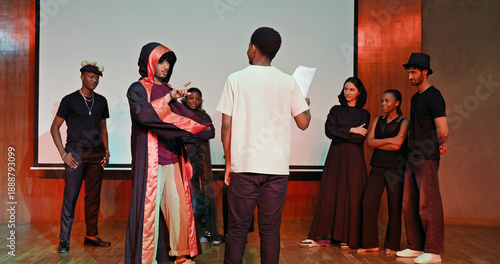 Canvastavla African young adult gen z male man hold scripts paper read play story lines scene standing indoor stage hall