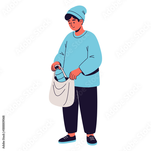 A young man wearing a blue beanie and sweater placing items into a white cloth shopping bag with dark pants and shoes person carrying groceries reusable