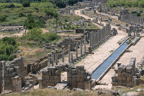 View from the hill to the ruins of the ancient city of Perga. An ancient city located in Turkey. Columns and a water channel in an ancient city. History and culture of ancient civilizations.