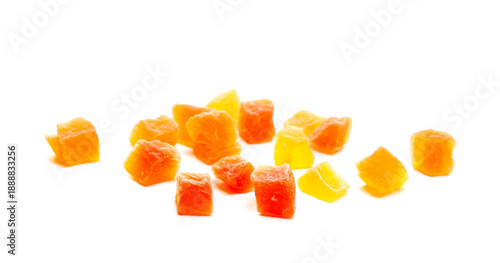 Tableau sur toile Group dried papaya cubes with sugar, closeup candied fruit isolated on white bac