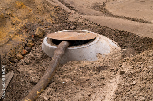 Septic tank pumping hose in ground during maintenance