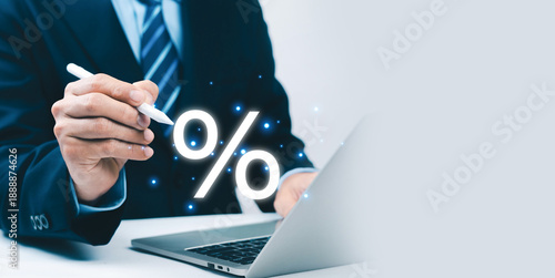 Business professional pointing percentage symbol on laptop screen, representing interest rate, financial analysis, discount strategy, profit calculation, and modern digital finance concept.