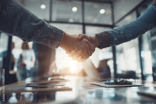Business partners shaking hands in modern office during meeting