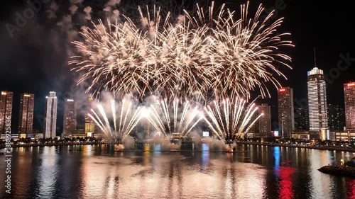 Celebratory Fireworks Over City Skyline by a Waterfront