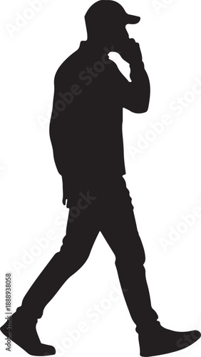 Side view silhouette of walking man in cap talking on mobile phone
