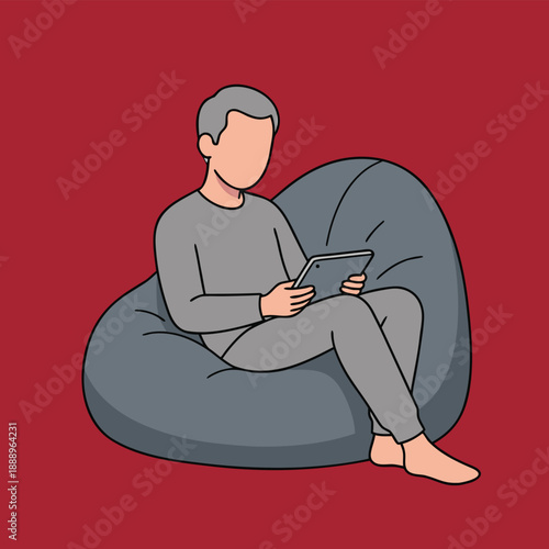 Man relaxing on a bean bag chair using a tablet.