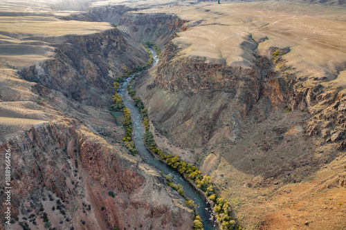 Wallpaper Mural Aerial view of a winding river cutting through a vast arid canyon landscape. Torontodigital.ca