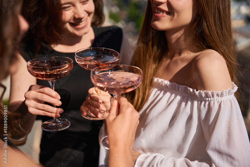Fototapeta premium Close up of smiling women with champagne glasses outdoors