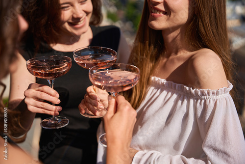 Close up of smiling women with champagne glasses outdoors